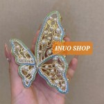 Pinza con forma de mariposa con perlas